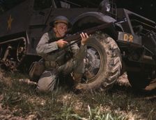 Infantryman with halftrack, a young soldier of the armed forces, holds..., Fort Knox, Ky., 1942. Creator: Alfred T Palmer