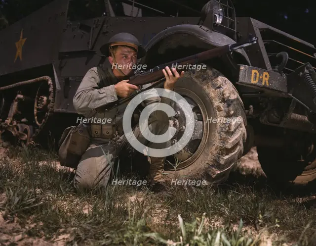 Infantryman with halftrack, a young soldier of the armed forces, holds..., Fort Knox, Ky., 1942. Creator: Alfred T Palmer.