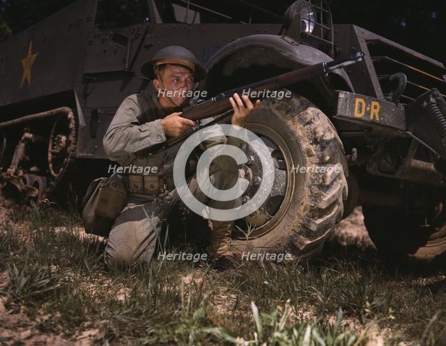 Infantryman with halftrack, a young soldier of the armed forces, holds..., Fort Knox, Ky., 1942. Creator: Alfred T Palmer.