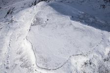 Ingleborough Iron Age univallate hillfort and hut circle earthworks in the snow, N Yorkshire, 2018. Creator: Emma Trevarthen