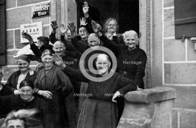 Inhabitants of a small town during a visit by Adolf Hitler, Franconia, Germany, 1936. Artist: Unknown