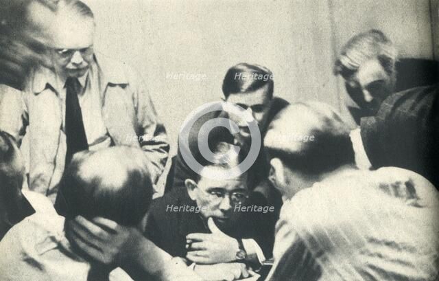 'Inside a German internment camp. Americans listen to London.', 1942. Creator: Unknown.