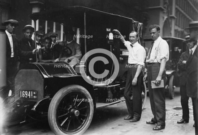 Inspector Walsh condemning taxicab, 1913. Creator: Bain News Service.