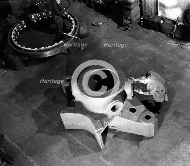 Inspecting a large precision steel casting, Sheffield, South Yorkshire, 1961. Creator: Michael Walters.