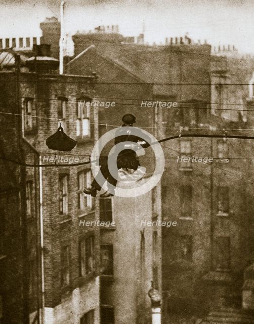 Inspecting a telephone cable between Conduit and Maddox Streets, 20th century. Artist: Unknown