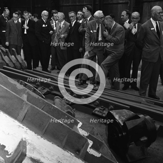 Inspecting a tram junction, made at the Edgar Allen Steel Foundry, Meadowhall, Sheffield, 1962. Creator: Michael Walters.