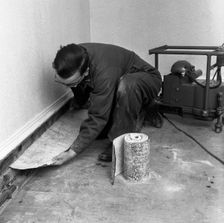 Installing a damp proof course in a house in Goldthorpe, South Yorkshire, 1957. Artist: Michael Walters
