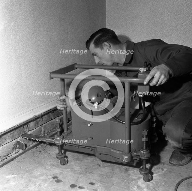 Installing a damp proof course in a house in Goldthorpe, South Yorkshire, 1957.  Artist: Michael Walters