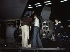 Installing an engine at the Consolidated Aircraft Corporation plant, Fort Worth, Texas, 1942. Creator: Howard Hollem