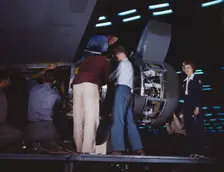 Installing an engine at the Consolidated Aircraft Corporation plant, Fort Worth, Texas, 1942. Creator: Howard Hollem