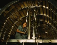 Installing oxygen flask racks above the flight...Consolidated Aircraft..., Fort Worth, Texas, 1942. Creator: Howard Hollem