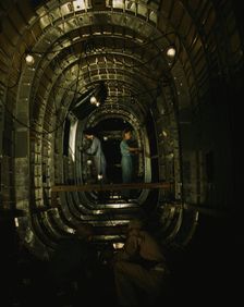 Installing structural parts of a C-87 transport...Consolidated Aircraft..., Fort Worth, Texas, 1942. Creator: Howard Hollem