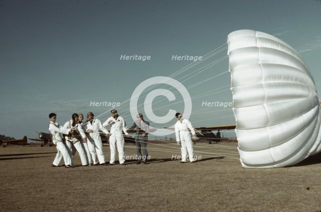 Instructor explaining the operation of a parachute to student pilots, Fort Worth, Tex., 1942. Creator: Arthur Rothstein.