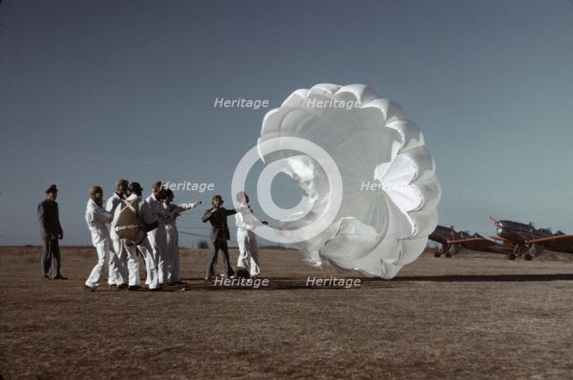 Instructor explaining the operation of a parachute to student pilots, Fort Worth, Tex., 1942. Creator: Arthur Rothstein.