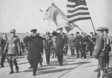 Iceland visit. Churchill - with Ensign Franklin D. Roosevelt Jnr. following - saluting the Stars an