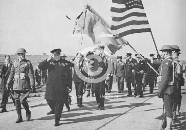'Iceland visit. Churchill - with Ensign Franklin D. Roosevelt Jnr. following - saluting the Stars an