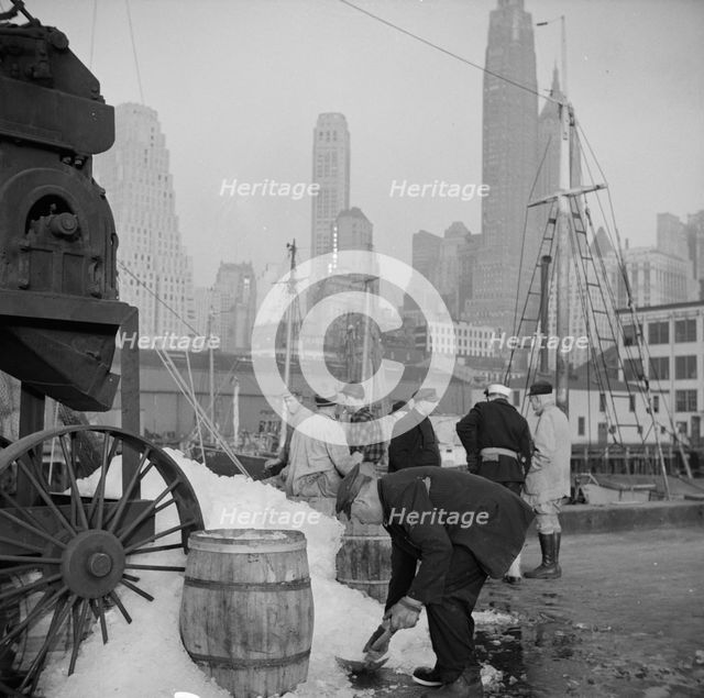 Icing barrels of fish at the Fulton fish market, New York, 1943. Creator: Gordon Parks.