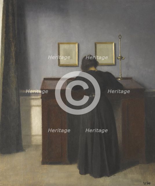 Ida Standing at a Desk. Artist: Hammershøi, Vilhelm (1864-1916)