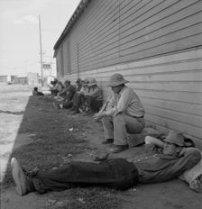 Idle men seated in shade on the other side of..., Tulelake, Siskiyou County, California, 1939. Creator: Dorothea Lange