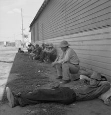 Idle men seated in shade on the other side of..., Tulelake, Siskiyou County, California, 1939. Creator: Dorothea Lange