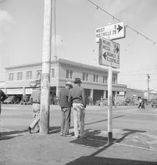 Idle pea pickers discuss prospects for work, Calipatria, Imperial Valley, California, 1939. Creator: Dorothea Lange