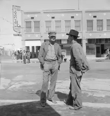 Idle pea pickers discuss prospects for work, Calipatria, Imperial Valley, California, 1939. Creator: Dorothea Lange