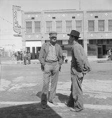 Idle pea pickers discuss prospects for work, Calipatria, Imperial Valley, California, 1939. Creator: Dorothea Lange