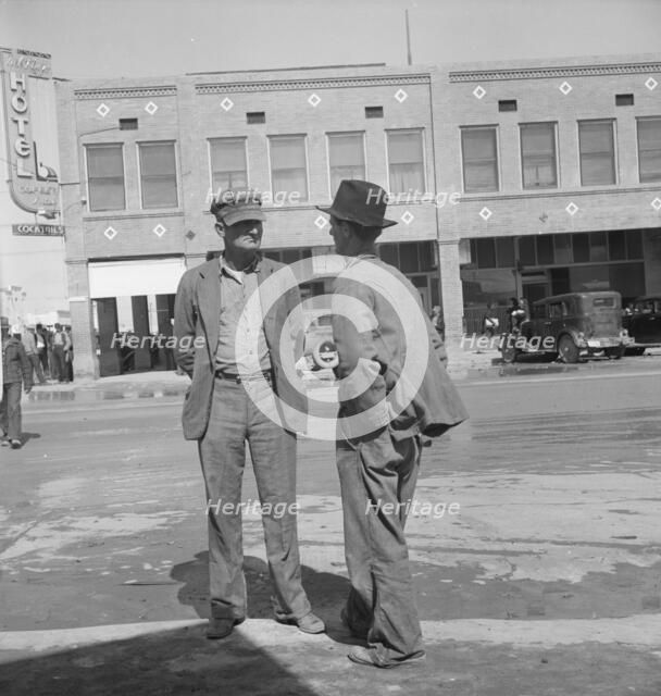 Idle pea pickers discuss prospects for work, Calipatria, Imperial Valley, CA, 1939. Creator: Dorothea Lange.