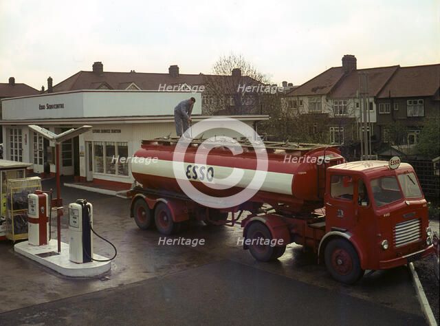 Ilford Esso petrol station with Leyland tanker making delivery 1964. Creator: Unknown.