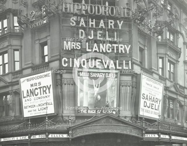 Illuminated advertisements on the front of The Hippodrome, Charing Cross Road, London, 1911. Artist: Unknown.