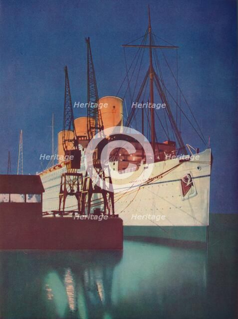'Illuminated by Floodlights, the distinctive appearance of the Empress of Britain is emphasized', 19 Artist: Unknown.