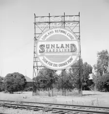 Illuminated sign, approaching San Joaquin Valley town, outskirts of Fresno, on U.S. 99, CA, 1939. Creator: Dorothea Lange