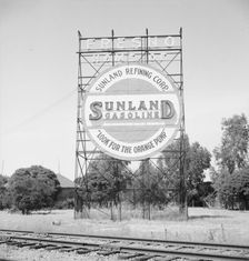 Illuminated sign, approaching San Joaquin Valley town, outskirts of Fresno, on U.S. 99, CA, 1939. Creator: Dorothea Lange
