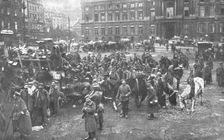 Ils S'en Vont; Unrassemblement allemand sur la place Saint-Lambert, a Liege; au fond..., 1918. Creator: Unknown