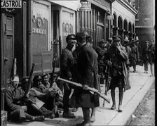 Irish Soldiers Sitting in the Street and Tending to Their Injuries from Fighting in Dublin, 1922. Creator: British Pathe Ltd