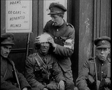 Irish Soldiers Sitting in the Street and Tending to Their Injuries from Fighting in Dublin, 1922. Creator: British Pathe Ltd