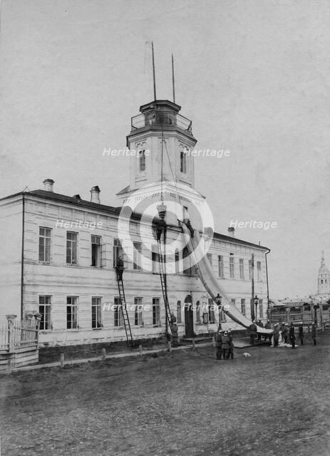 Irkutsk police fire brigade. Exercise with a rescue sheet and a rescue basket, 1894. Creator: R Prorokov.