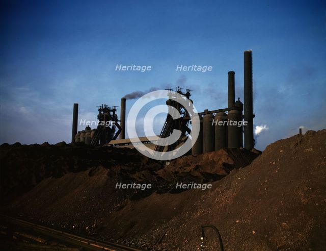 Iron ore piles and blast furnaces, Carnegie-Illinois Steel Corporation mill, Etna, Pa., 1941. Creator: Alfred T Palmer.