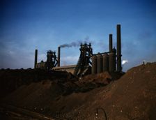 Iron ore piles and blast furnaces, Carnegie-Illinois Steel Corporation mill, Etna, Pa., 1941. Creator: Alfred T Palmer