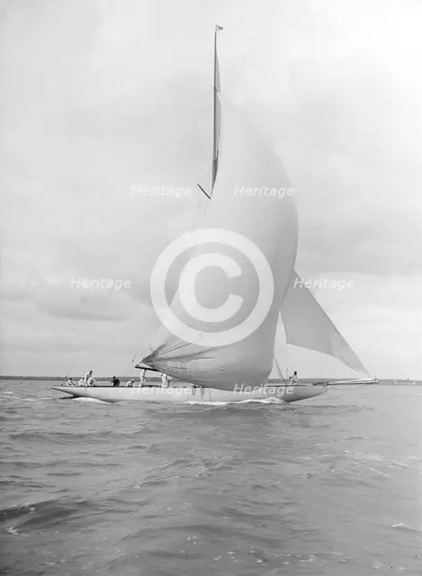 'Istria' sailing downwind under spinnaker, 1912.  Creator: Kirk & Sons of Cowes.
