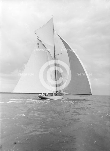 'Istria' sailing downwind under spinnaker, viewed from stern, 1912.  Creator: Kirk & Sons of Cowes.