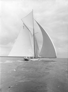 Istria sailing downwind under spinnaker, viewed from stern, 1912. Creator: Kirk & Sons of Cowes