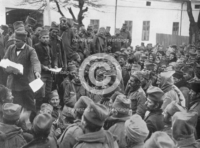 'Issuing passes for a few days leave at home to the wounded Serbian troops at Nish', 1915. Artist: Unknown.