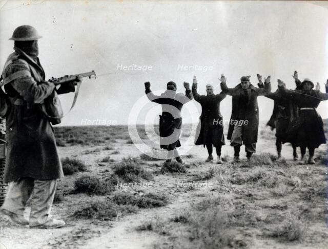 Italian troops surrender to an Australian soldier, Bardia, Libya, World War II, 1941. Artist: Unknown