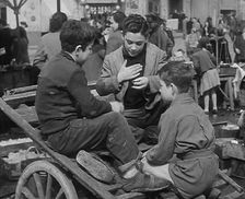 Italian Boys Talking With Other Civilians in the Background, 1944. Creator: British Pathe Ltd