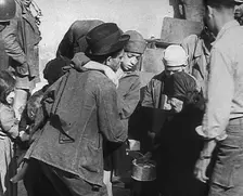 Italian Civilians Getting Assistance from American Soldiers in a Bomb-Damaged Italian Town, 1943-44. Creator: British Pathe Ltd