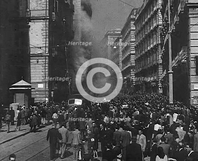 Italian Civilians Moving Slowly Through Bomb-Damaged Naples, 1943-1944. Creator: British Pathe Ltd.