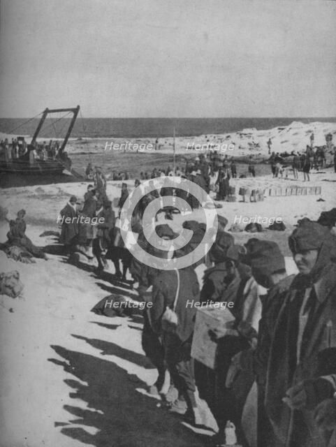 Italian prisoners captured by the British assisting in the loading of a store ship, 1941. Artist: Unknown.