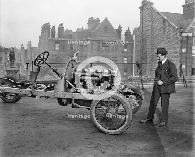 Italian racing driver Giulio Foresti with the chassis of a car, London, 1918-1919. Artist: Bedford Lemere and Company.