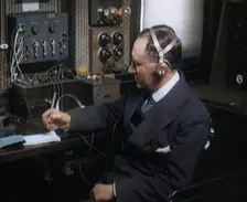 Italian Senator Guglielmo Marconi Using Radio Apparatus While Taking Notes, 1920. Creator: British Pathe Ltd
